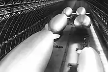 Six helium-filled blimps stored in one of the two hangars at MCAS Tustin, date unknown.