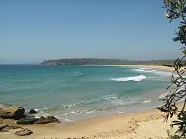 View of a beach, bay and distant headland