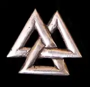 A metallic Valknut in the shape of a trefoil