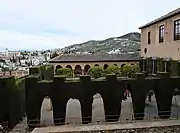 View of the Patio de Machuca from the south (the trimmed cypresses  stand in for the lost porticos)