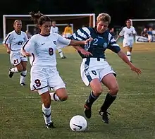 Image 5Mia Hamm (left) battles with German defender Kerstin Stegemann (from Women's association football)