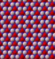 View of trioctahedral sheet structure of biotite. The binding sites for apical oxygen are shown as white spheres. Red spheres are hydroxide ions.