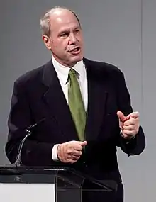 Man in a tuxedo giving a speech