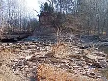 The remains of the 18th-19th century cut across the peninsula of the Jug, as viewed in 2006.  The creek is partially prevented from flowing here by the dam effect of the low water bridge visible at left (see photograph below); the creek is slightly visible at right, having emerged from a 3.3 mile (5.3 km) meander.