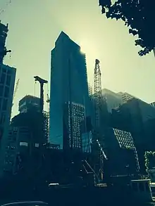 The cranes constructing the foundation, in front of the Millennium Tower and Transbay Terminal, and in the distance the Salesforce Tower and 181 Fremont Tower under construction.