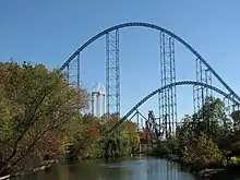 Two roller coaster hills over a lagoon