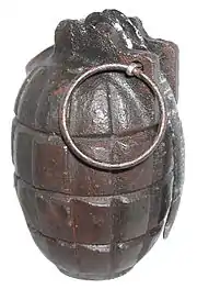 a steel hand grenade with lever and pin in place