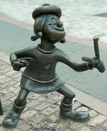 Image 34Statue of Minnie the Minx, a character from The Beano, in Dundee, Scotland. Launched in 1938, The Beano is known for its anarchic humour, with Dennis the Menace appearing on the cover. (from Culture of the United Kingdom)