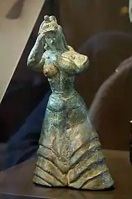 Bronze Minoan figure in Berlin, LM I, probably a worshiper, with either snakes or tresses of hair.