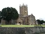 Elaborately ornamented stone building with square tower.