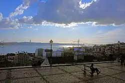 The scenic overlook of Miradouro da Santa Catarina, showing a view of the Tagus River and local neighborhoods