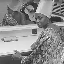 Makeba seated at a counter