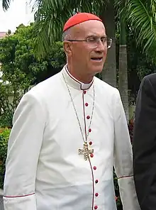 Catholic Cardinal Tarcisio Bertone wearing a tropical white cassock trimmed in cardinalatial scarlet in Santo Domingo, Dominican Republic (2006)