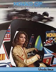 A woman in a racing driver uniform sitting in an arcade cabinet behind a steering wheel