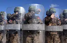 Members of the Mongolian Armed Forces and Internal Forces practice crowd control techniques as a part of Non-Lethal Weapons Executive Seminar 2010 at 5 Hills Training Facility, Mongolia, June 2010.