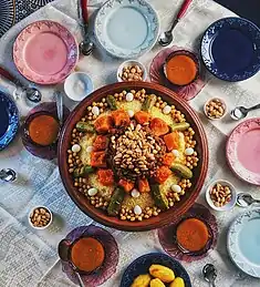 Couscous with vegetables, topped with tfaya and toasted almonds