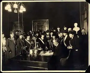 Black and white photograph of many women watching the Kentucky Governor signing a bill