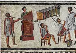 Musicians playing a Roman tuba, a water organ (hydraulis), and a pair of cornua, detail from the Zliten mosaic, 2nd century AD