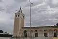 Front of the mosque, with an arcade or portico along its façade (right)