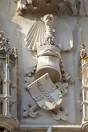 Portuguese coat of arms, with the Cross of the Order of Aviz as supporter and the dragon as crest, in a late 14th-century gate of the Batalha Monastery