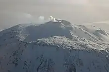  Distant view of a mountain with a smoke emission from its summit