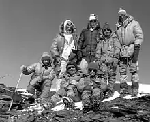 Image of seven mountain climbers wearing winter gear and standing together