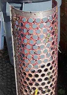 Image 6Central component of a mechanical destemming. Paddles above the small circular slots rotate to remove the larger chunks of stems. Grapes are pulled off the stems and fall through the holes. Some small amount of stem particles are usually desired to be kept with the grapes for tannin structure. (from Winemaking)