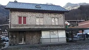 Two-story stone building with gabled roof