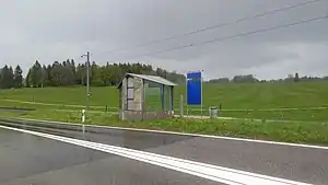 Covered shelter on side platform next to roadway