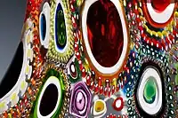 Close up of pattern of different murrine incorporated into blown glass.