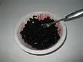 Blueberries are crushed by a fork or spoon