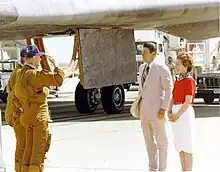 Henry Hartsfield and Ken Mattingly salute the Reagans after landing.