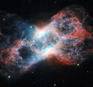 This image of NGC 7026 shows starlight in green, light from glowing nitrogen gas in red, and light from oxygen in blue.