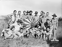 Image 36New Guinea Volunteer Rifles with captured Japanese flag, 1942 (from History of Papua New Guinea)