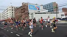 Group of runners with buildings in the background