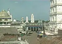 a view of street with minaret in the background