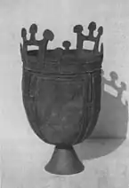 A cauldron with geometric motifs and mushroom-like shapes on the handles