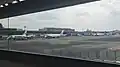 Terminal 2 main building with parked planes of Oneworld carriers Japan Airlines, China Airlines, and Cathay Pacific