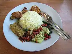 Nasi campur Bali served with ayam betutu and vegetables