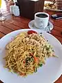 Nasi goreng and bihun goreng served with coffee at breakfast in an Indonesian hotel.