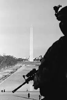 Image 32Photograph of a National Guardsman looking over the Washington Monument in Washington D.C., on January 21, 2021, the day after the inauguration of Joe Biden as the 46th president of the United States (from Photojournalism)