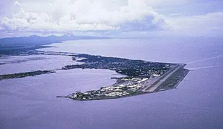 Aerial view of base and Cavite City (c. 1964)on Cavite Peninsula in Manila Bay.