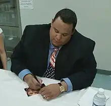 Boyd signing an autograph