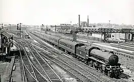 In the centre is a steam locomotive with a train of carriages.  Around the sides, several points  allow for easy access to the different routes.