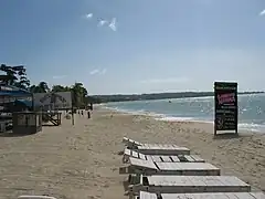 A beach in Negril with a hotel and restaurant