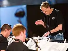 (L-R) Michel Machietto (alto sax), Isaac Lamar (tenor sax), Neil Slater conducting the One O'Clock Lab Band at the Umbria Jazz Festival, July 18, 2008