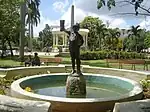 Between the fountain with the Niño statue and the Glorieta is an obelisk honoring the city's first priest