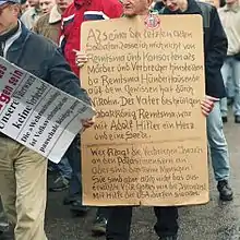 Protesters against the Wehrmacht Exhibition in 2002. The exhibition detailed the war crimes of the Wehrmacht. One of the posters reads: "Our fathers were not criminals"