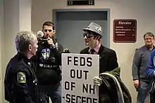 A man holds a sign advocating for secession during the 2012 presidential campaign