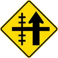 (W15-1A/PW-13a) Railway level crossing on side road to left